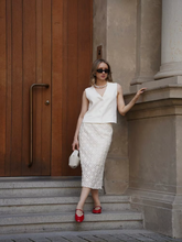 A woman wears a skirt made of sheer fabric